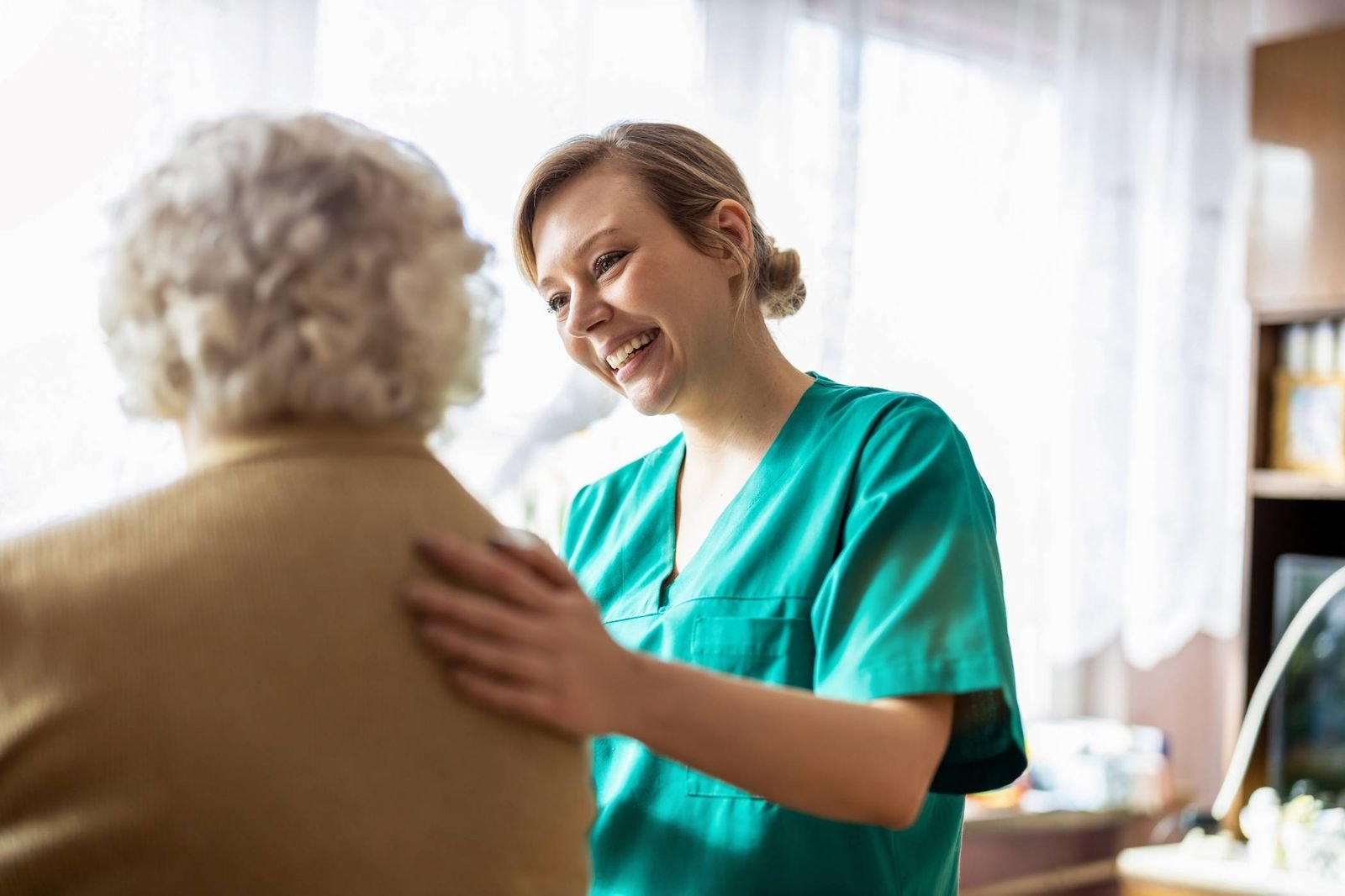 Caregiver sharing a warm conversation with a senior client