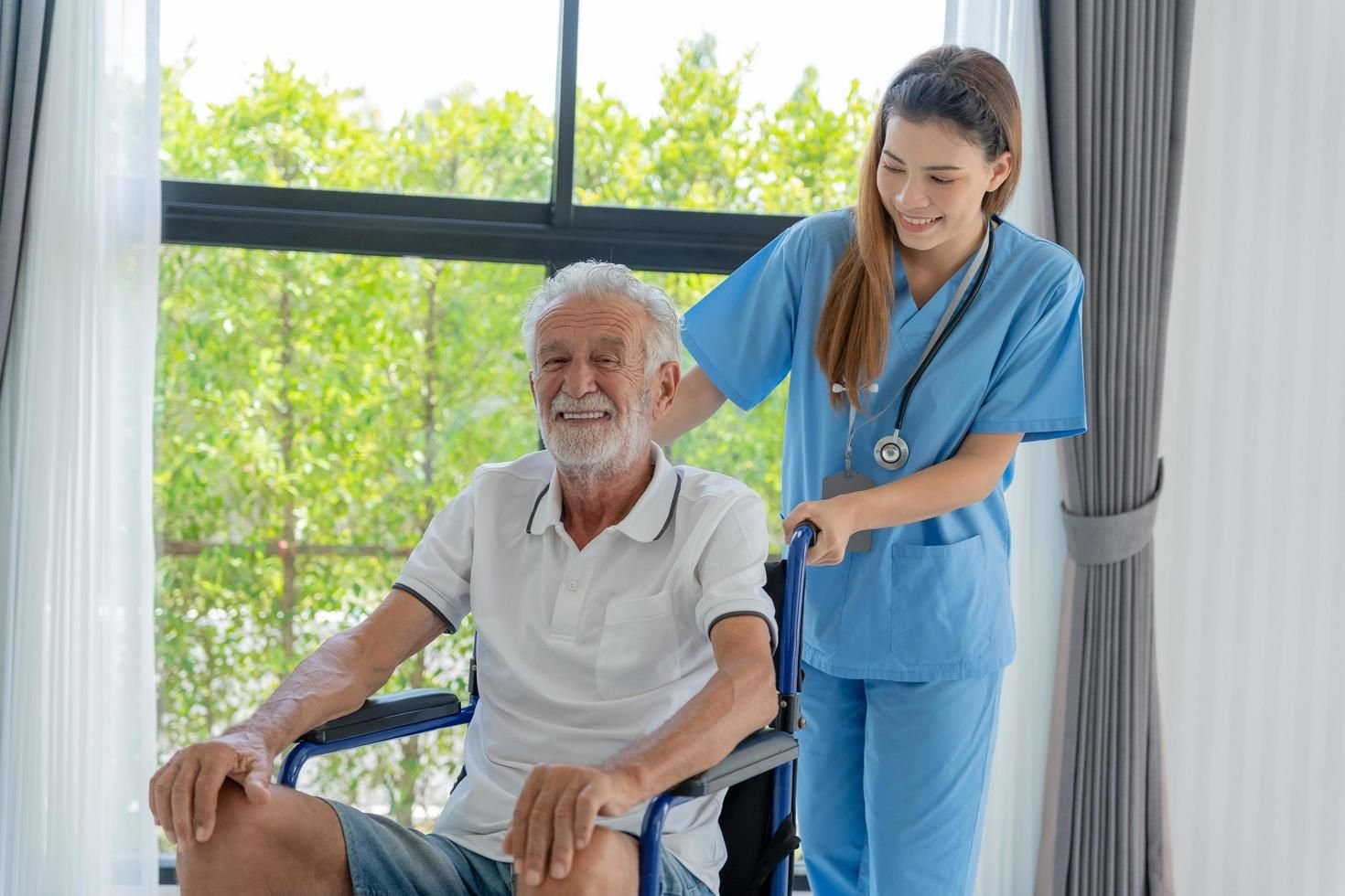 Caregiver helping a senior man stay mobile and independent at home